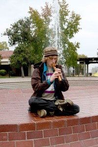 Anthropology major Devon Carsen, 19, meditates while playing the flute Oct. 12 at the fountain on the quad at City College.||Photo illustration Randy Briggs||briggs@imail.losrios.edu