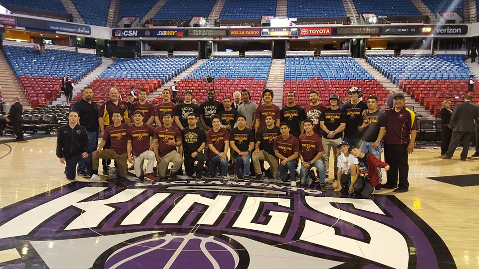 City College wrestling team gathered for a team picture after the Kings game Feb. 29. Photo by David Pacheco.