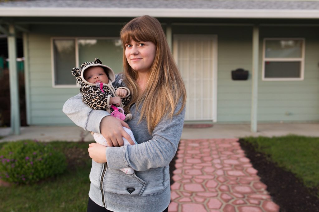 City College student Anita Stupina poses for a photo with her foster child in front of her home in West Sacramento on Nov. 23, 2016. Hector Flores, Staff Photographer. | hectorfloresexpress@gmail.com