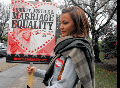 Annelisa Moody proudly holds a sign for liberty, justice & marriage equality while marching around the Capitol on Feb. 16.