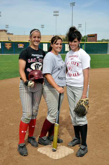 City College softball players pose on the softball field April 29: (from left) Andrea Argee and Lindsey Bruno, chosen for the First Team All Conference, and Kelli Reynolds, Most Valuable Pitcher for all Big 8 Conference selections.