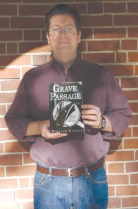 Anthropology professor William Doonan poses with his new book “Grave Passage.” ||Kristen Stauss || staussk@imail.losrios.edu