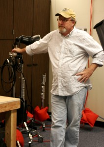 Photography professor Randy Allen works in the City College photography studio setting up lights for a shoot.