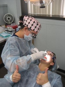 Fishback cleans friend Rebecca Mudd's teeth at the City College dental office.