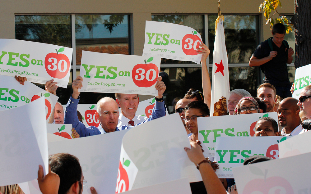 Gov. Jerry Brown held up his Yes on 30 banner and excited City College students and supporters followed.  Kate Paloy | katepaloy.express@gmail.com