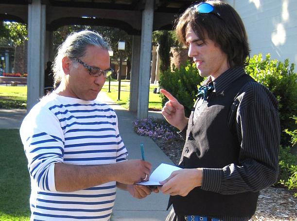 Artist Arthur Gonzalez (left) signs an autograph for student Allan Pryor, art major.  Kelvin Sanders, kassr2000@gmail.com