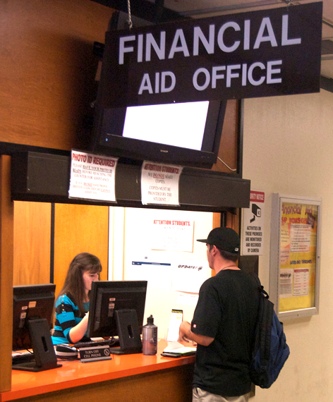 Lyubov Kuru, a clerk of two years, helps a student at the Financial Aid window located in Rodda Hall North.  Callib Carver | CallibCarver.express@gmail.com