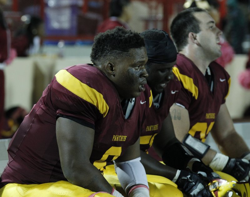 Panther defensive lineman Keivaughn Barrett, No. 9, rests beside  his teammates after several successful plays in the game against the Merced Blue Devils on Oct. 6, 2012.  Kate Paloy | katepaloy.express@gmail.com