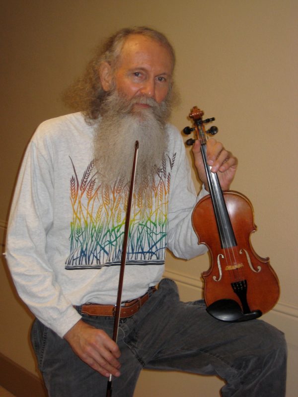 Bob Wrenn poses with  his violin  in the corridor of the Performing Arts building. Wrenn has been a music professor at City College for 11 years. Kelvin Sanders |kassr2000@gmail.com