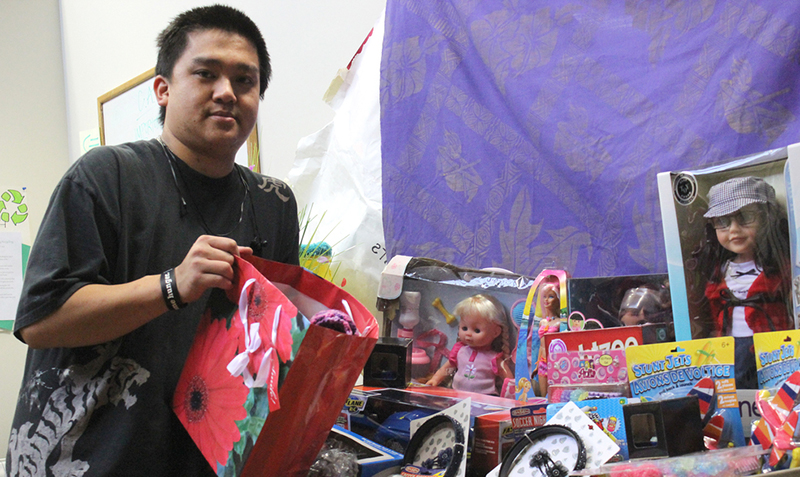 President of Clubs and Event Board (CAEB), Paul Kuang, stands with the toy donations for the toy drive and talent show his club hosted on Dec. 5, 2012. Tony Wallin | wallintony@yahoo.com