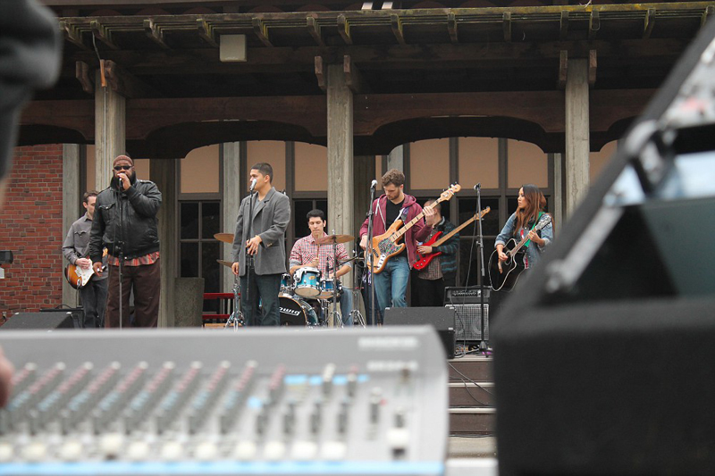 A band playing on the stage in the City College Quad.