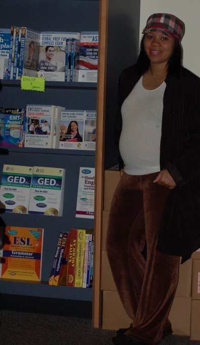 Latrice Watts stands near the shelves of pretest study guides in the student book store.  She is due to have her baby in December 2012.  Kate Paloy | katepaloy.express@gmail.com