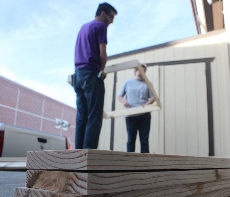 Theatre students, Charles Demmon, 20, and Tabitha Angier, 21, work on a set and build a window for the upcoming play 