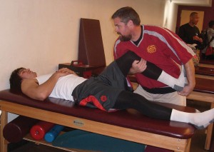 Jude Temple,City College head athletic trainer, stretches Maxx Pacheco, who is an injured track and football player, in the training room on Tuesday January 29, 2013. Raionna Nasmyth | Raionnadymond@gmail