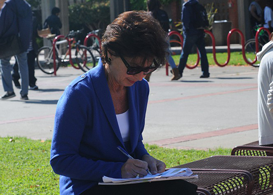 PICTURE OF THE DAY – 4/15/13 Art History student Barbara Aved to go over her class notes under the mild and sunny weather while sitting at the Quad on April 15. | Rafael Baez | rebaez@sbcglobal.net
