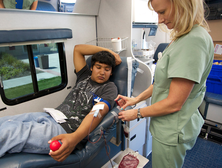 PICTURE OF THE DAY – 4/24/13 Paul Carbajal, 19, Psychology Major donates blood for a free T-shirt for nurse Kristen Graves in the Blood Source buses for the Blood Drive, Wednesday April 24. | A.J. Phillips | w1103744@apps.losrios.edu