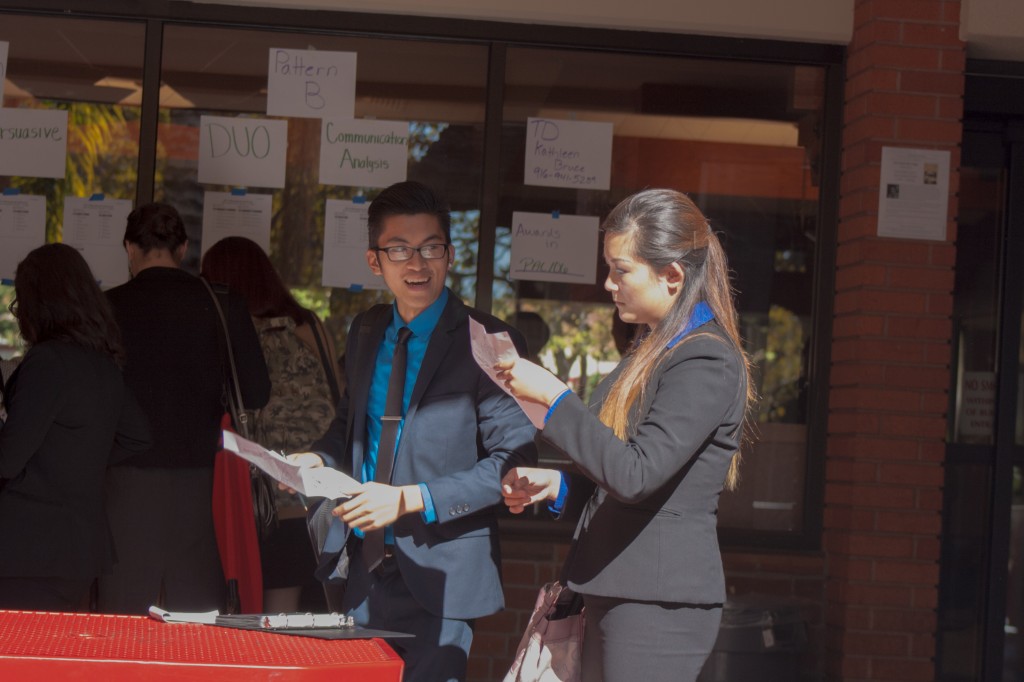 Speech and debate hopefuls of the San Joaquin Delta College’s Mustang Invitational, hosted by City College, gather Friday outside City Cafe locating their names on roster schedules for their next event. (Teri Barth // photographer // express.teri.barth@gmail.com)
