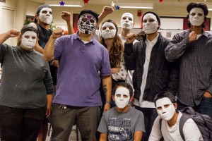 Xico Gonzales (third person from the right, purple shirt) displays the results of a mask-making workshop with student for Dia de Los Muertos (Day of the Dead) in the Cultural Awareness Cente4r on Halloween. // Tamara Knox // Staff Photographer // tmrknox@gmail.com 