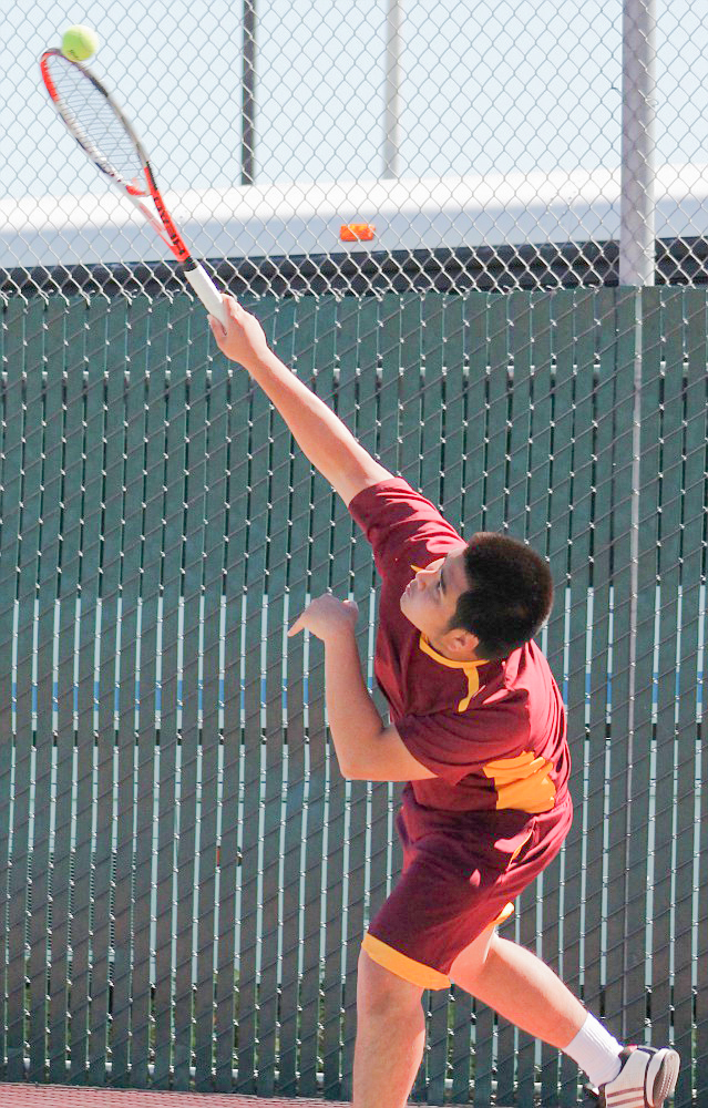 Panthers Nhan Cao serves during the home match against Reeley College March 18. Photo by Staff Photographer