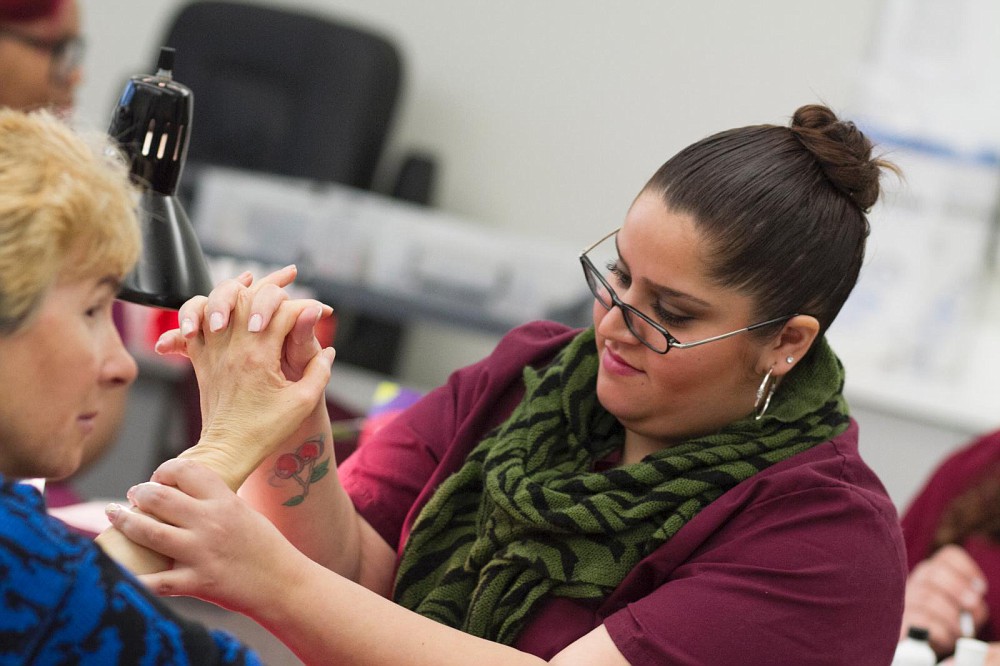 City College student nail technician Darling Demaro performs reflexology while giving a Cosmetology department client a manicure March 5. Photo by Tamara M. Knox l Online Photo Editor l tmrknox@gmail.com