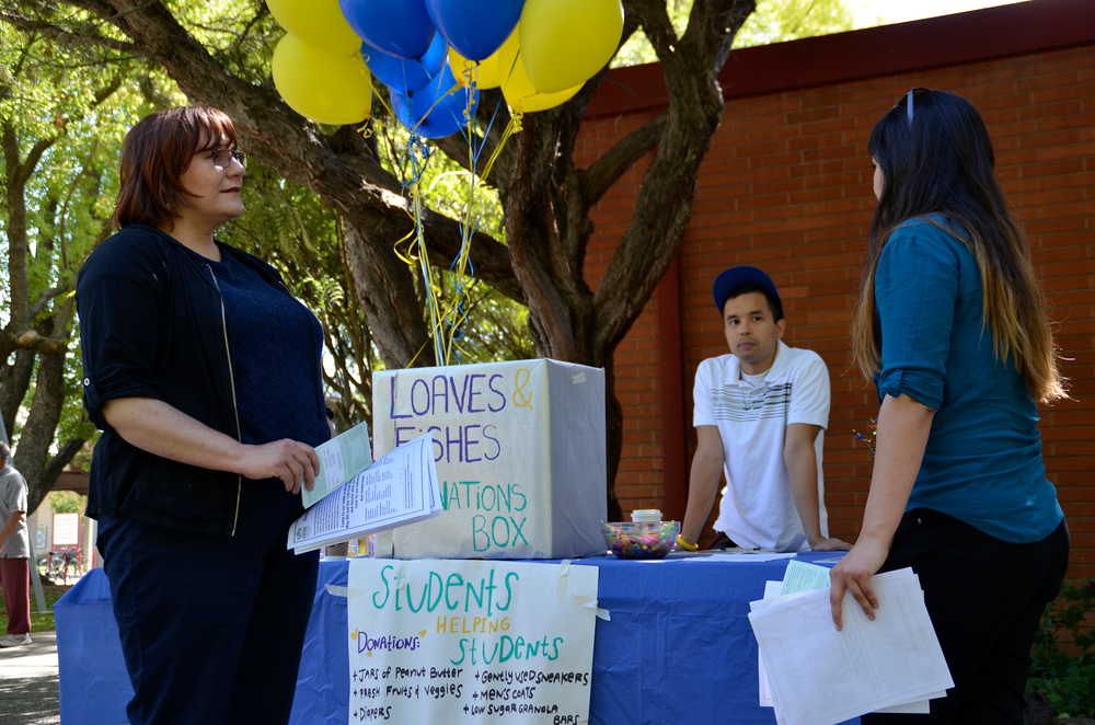 City College students Amy Hanak (left), Roen Afable and Olivia Reyes chat May 13 while waiting for donations for the homeless in Sacramento and Loaves and Fishes Mustard Seed School for homeless children. The students previously collected hygiene items, clothes and guests gear during Peoples Day May 8 in the Quad. Elizabeth Ramirez | Staff Photographer | elizabethramirezexpress@gmail.com