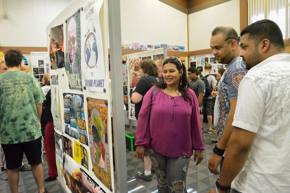 Friends and family view City Colleges 2013-14 Graphic Communication students cyberpunk-themed designs during the Graphic Communications Year End Show in the Cosmetology building, May 20. Emily Foley | Staff Photographer | emmajfoley@gmail.com