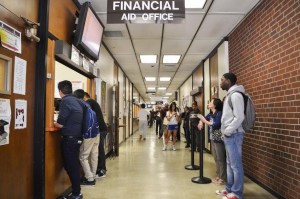 The long line of financial aid continues along through the beginning of the semester as City College students wait to hear their name get called in the Rhodda North Hall Building. Emily Foley | Staff Photographer <span id=