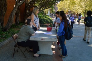 City College foundation workers, Ann Love (left) and Rachel Larsen (right),  converse with students about information regarding scholarship requirements outside of the City Cafe. Emily Foley | Staff Photogrpaher <span id=