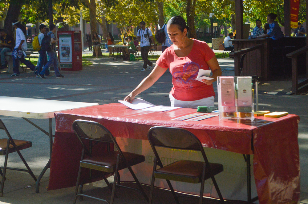 DSPF City worker Nicole Keller sets up her Disabilities services for students booth and gets ready for Welcome Day by City Cafe, Sept. 11, 2014. | Emily Foley | Staff Photographer | emmajfoley@gmail.com |