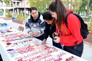 Wendy Rodriguez, (left) owner of the craft stand, assists City College nursing students Monica Castillo Perez (middle) and Yridiana Rivera (right) select a bracelet. Perez and Rivera have a four hour break from their nursing classes and decided to shop. Rodriguez has brought her crafts stand to City College for the past two years. Elizabeth Ramirez|Staff Photographer|elizabethramirezexpress@gmail.com