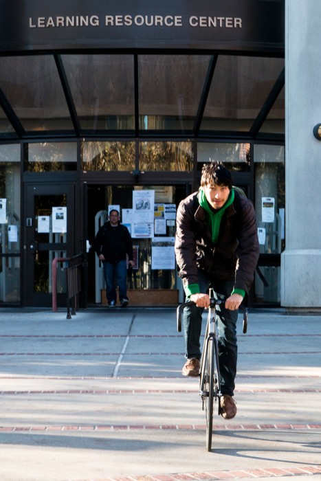 City College Sociology major, Amilio Palomares, 21, who enjoys riding his bike to school, just returned books he borrowed from the City College Library. He enjoys using the library and says the books he’s able to check out help him with his assignments. 
Photo by Penelope Kahn | penelopekahn@yahoo.com