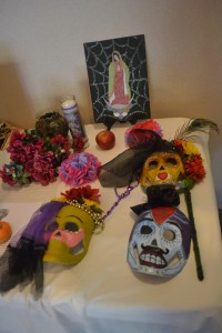 The City College Dia De Los Muertos exhibit in the LRC was complete with  pictures of Mother Mary and handmade colored masks. Gabrielle <span id=