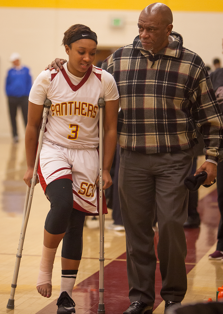 City College injured sophomore guard, Rayelle Ross, is comforted by her father, Ray Ross, after the game against Delta College at the North Gym on Jan. 23rd. 

Dianne Rose/dianne.rose.express@gmail.com