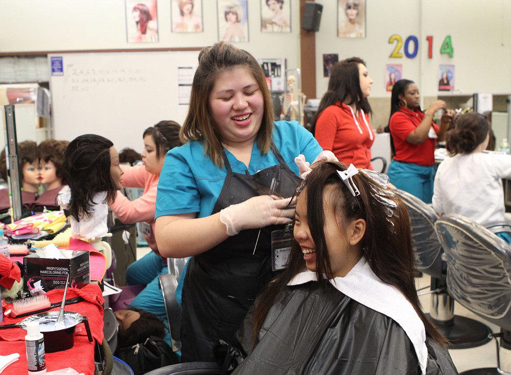 City+College+Cosmetology+students%2C+Kaozer+Vang+and+Mai+Yang+practice+highlight+application+in+class+February+11%2C+2015.+Vanessa+Nelson+%7C+Staff+Photographer