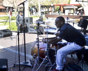 City College music student, Austin Mitchell sets up a drum set for the Commercial Music Ensemble class performance outside Student Center February 3, 2015. Emily Foley | <span id=