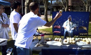 City College club,  Omechs booth, charges $1 to throw a cupcake at professors for club day. Mechanical engineering student, Levi Hopson throws a cupcake at math professor Joseph Stever March 5,2015. Emily Foley | Photo Editor |