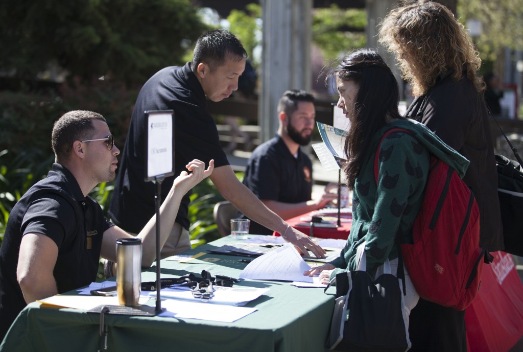 Enrollment Manager Jose A. Mejia speaks with City College Freshman XiaoXiao Yu, about transferring to CSU Sacramento at City's Transfer Day March 18, 2015. Vanessa Nelson | Staff Photographer