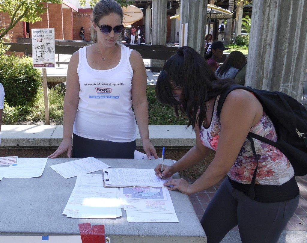 Anne Vorsatz (left) informs third year SCC student, Acelia Soto (right) of SB 277 Referendum petition. Aug. 31st, 2015.