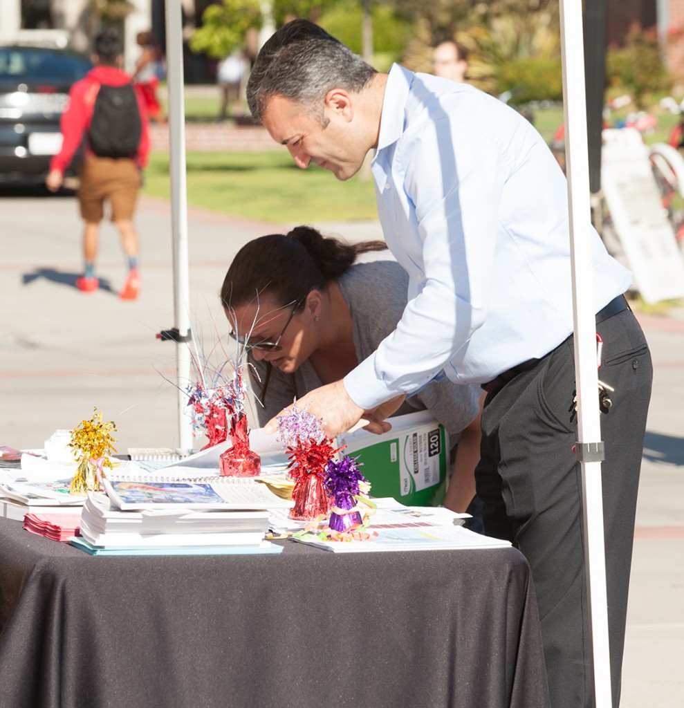 Catherine Llarena fashion major stops by the student information booth to grab a student guide from City College IT Supervisor Andy Divanyan on August 25, 2015 as classes get back under way this week at City College.