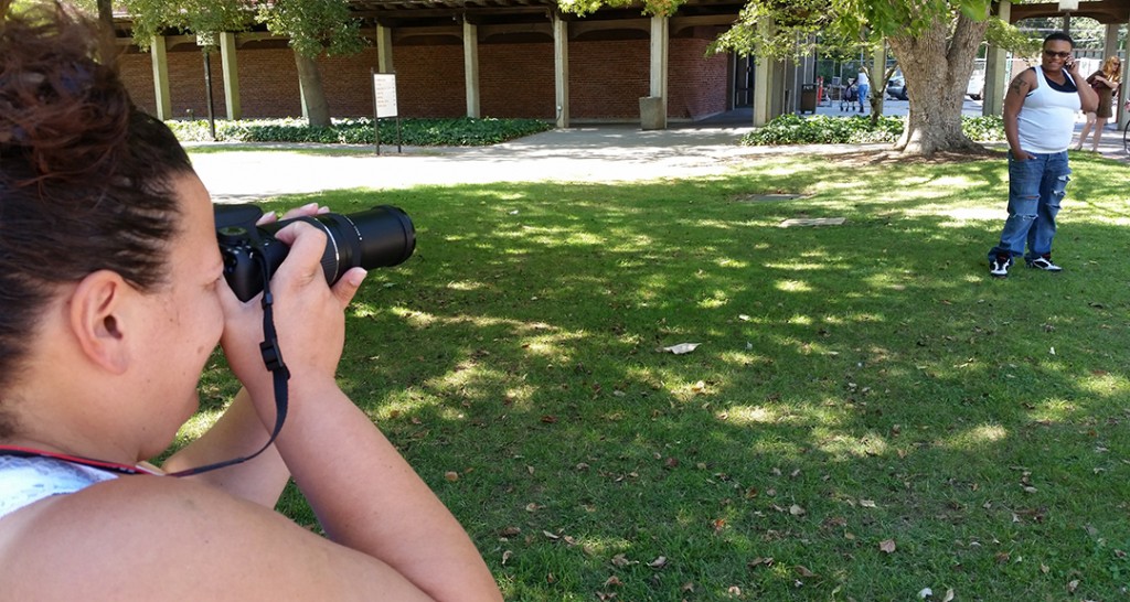 City College photography student Janelle Vega, 37, photographs her wife, Treva Washington, 41 music major, Sept. 3 at the main quad after finishing their classes for the day . Vega is a returing student looking for ways to expand her peotry business. She is enrolled in photography courses to help her create her own photo illustrations for her future poetry books. <span id=