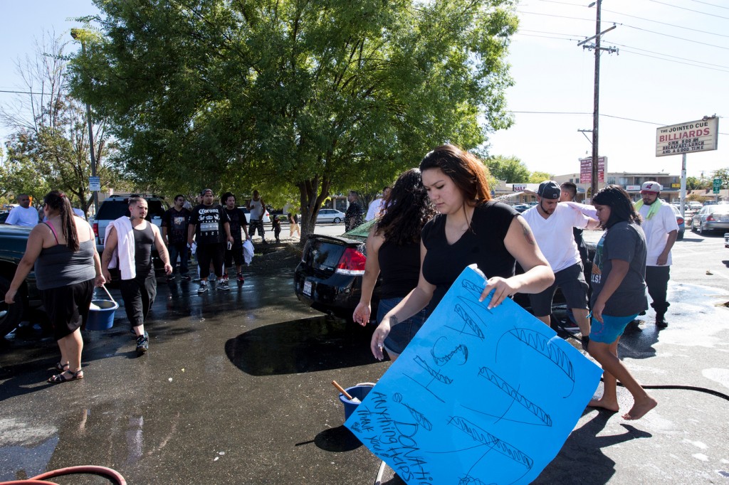 Members of the community brought together to honor Roman P. Gonzalez, and help raise money to benefit Gonzalez’s family through a carwash fundraiser Sept. 6, 2015. Emily Peterson | Staff Photographer | emilypetersonexpress@gmail.com