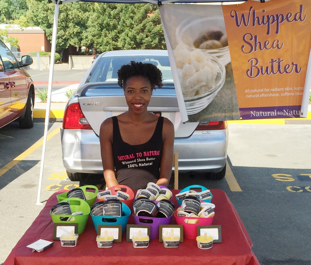 City College student Ashley Turner, owner of Natural to Natural, sitting at the Farmers' Market Sunday Aug. 31, 2015 selling her all natural shea butter.