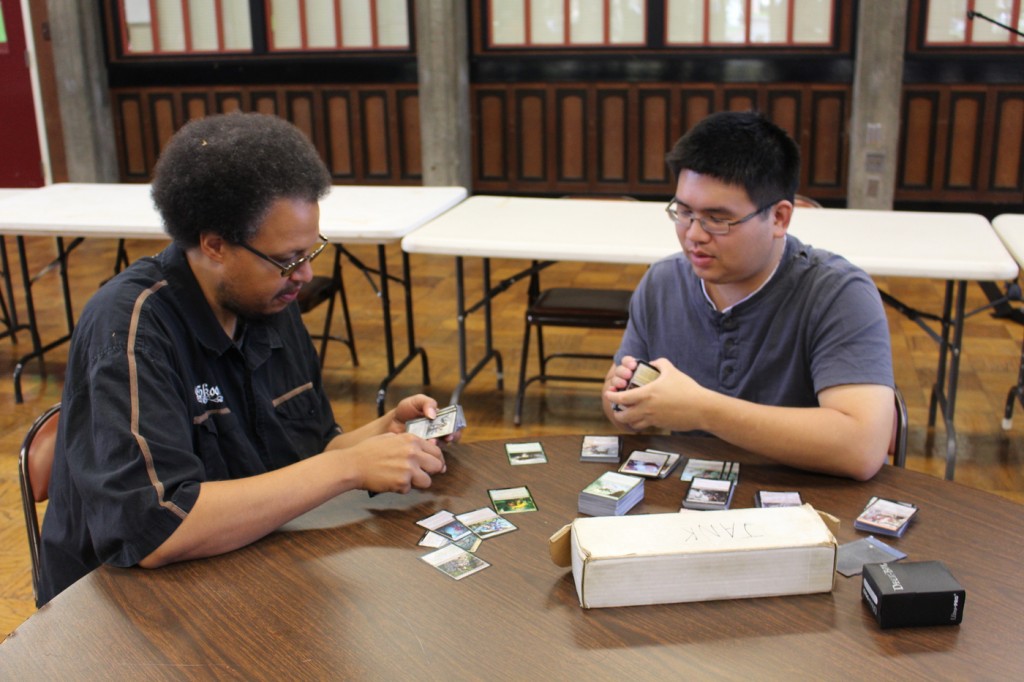 City College students Clarence Johnson (left) and Travis Sonico (right) discussing a strategy card game called Magic in the Student Center during a break between classes. Photo by: Julie Jorgensen 