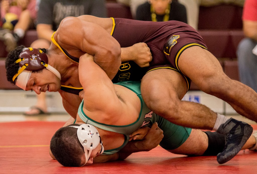 City College's Jason Zecchini tries to roll over Shasta College's Pat Pennick for the pin fall during their match in the North Gym Oct. 14. (Photo by: Kristopher Hooks | khooksexpress@gmail.com)