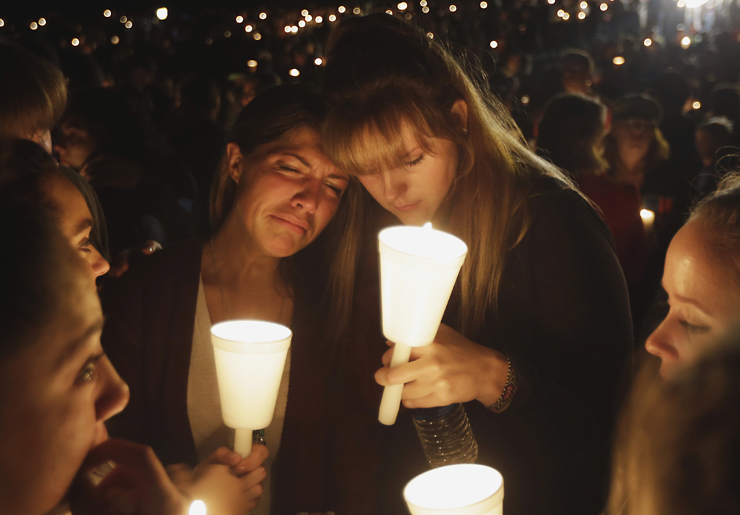 Kristen Sterner, left, and Carrissa Welding, both students of Umpqua Community College, embrace each other during a candle light vigil for those killed during a fatal shooting at the college, Thursday, Oct. 1, 2015, in Roseburg, Ore. (AP Photo/Rich Pedroncelli)