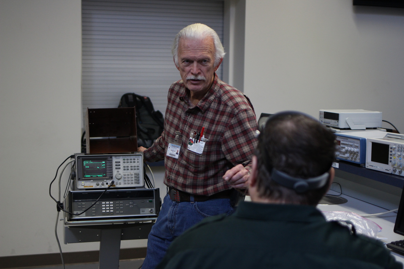 Professor Melvin Duvall offers advice on radio hardware during a test of a student-made radio antenna on Nov. 24. William Grubb | staff photographer