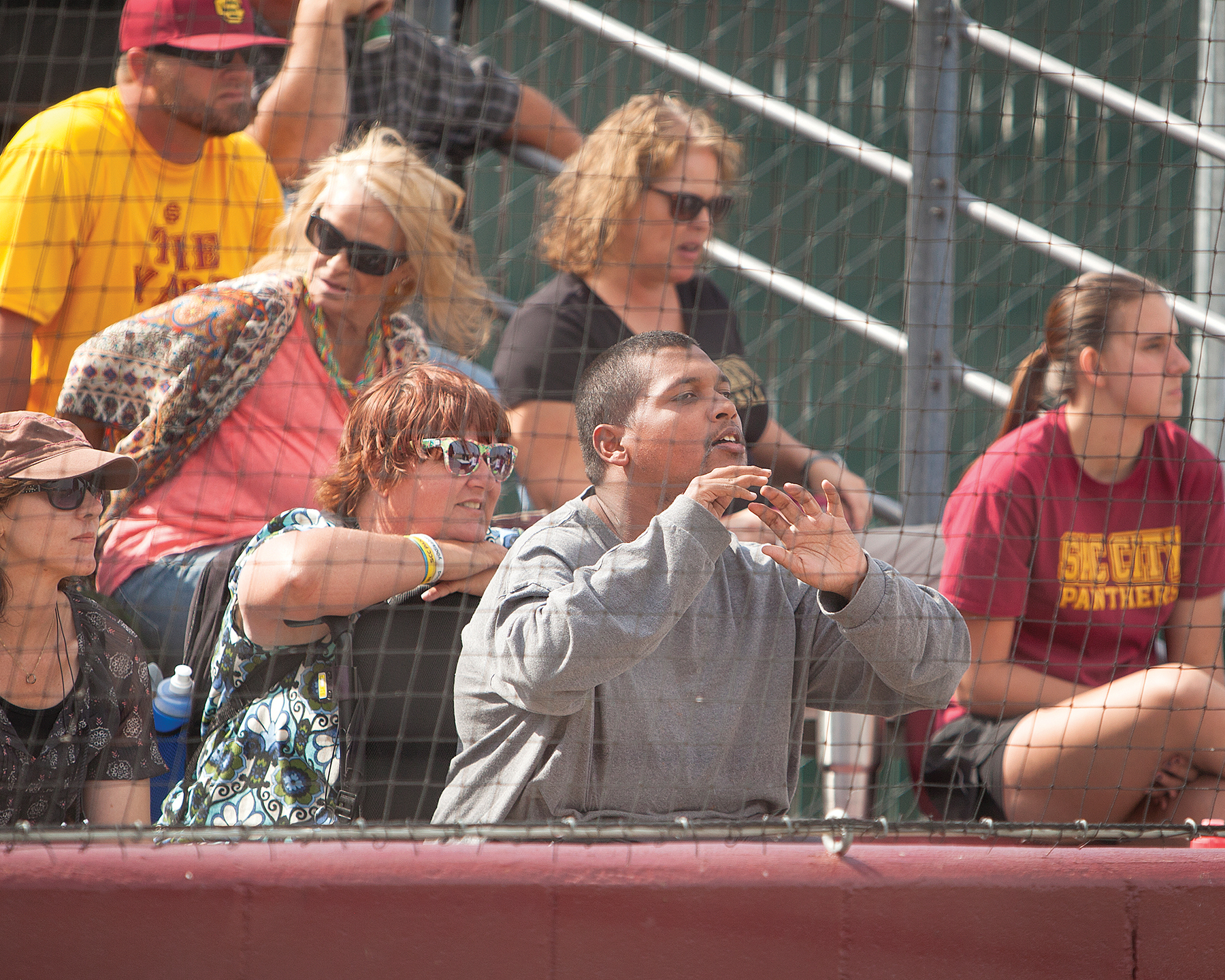 City College softball fan Anthony Federer cheers from behind home plate in the game against San Joaquin Delta College at The Yard on April 21st. Dianne Rose/diannekayphotos@gmail.com