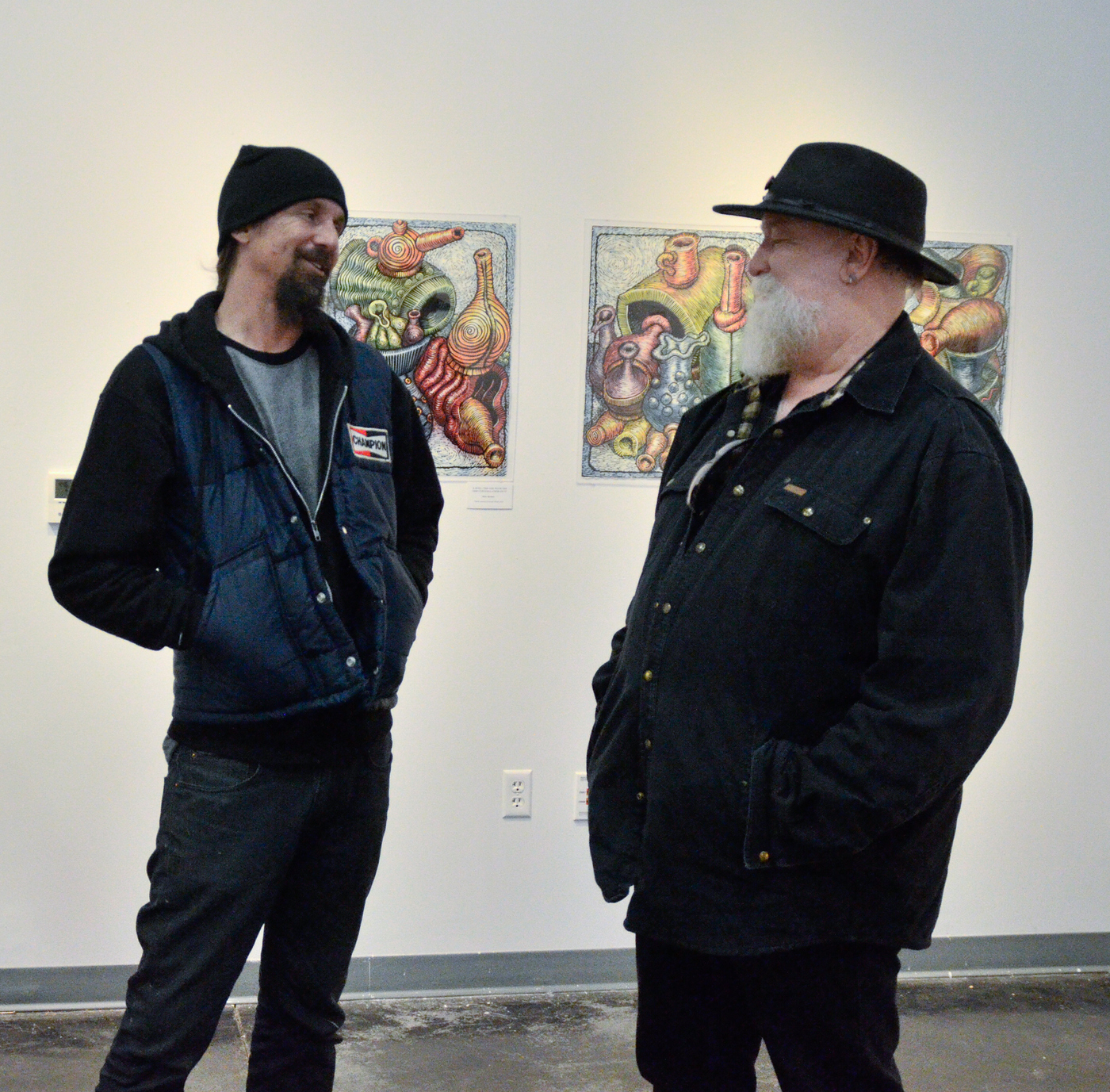 1- 21-16 Bruce Gosset, left, chatting with Mick Sheldon, right, the artist whose work is currently being displayed. Chris Williams, Staff Photographer. | Chriswexpress@gmail.com