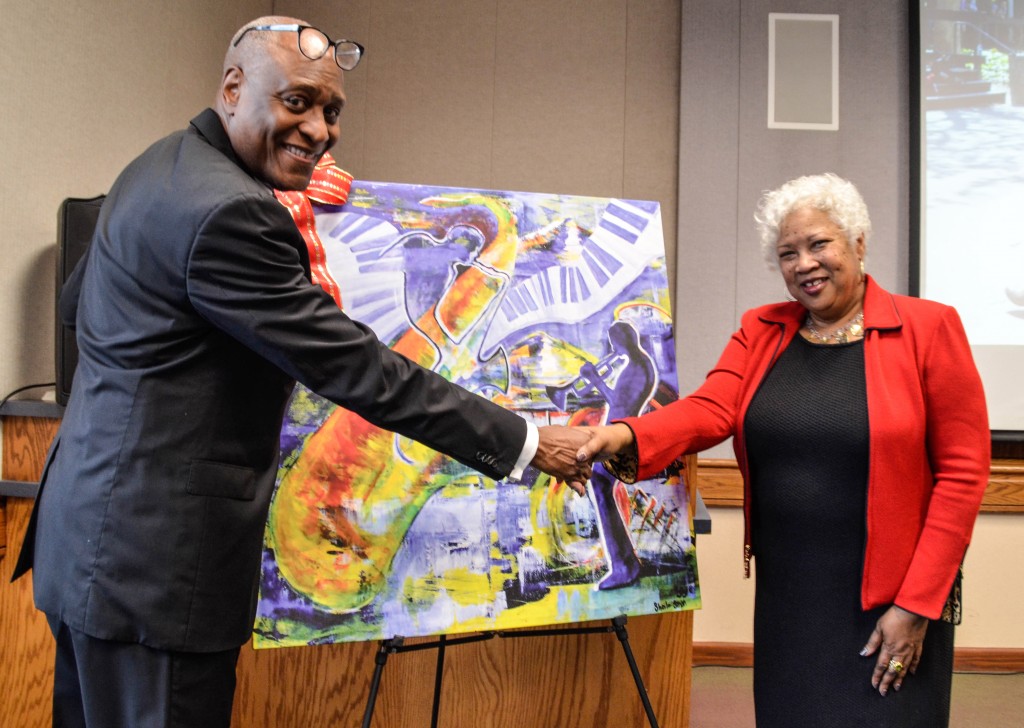 City College Vice President Michael Poindexter at Dr. Jeffery with Dr. Jeffery in front of a reproduction artwork for her at her reception on Thursday afternoon Jan. 28, 2016 Barbara Williams, staff photgrapher. | BarbarajExpress@gmail.com