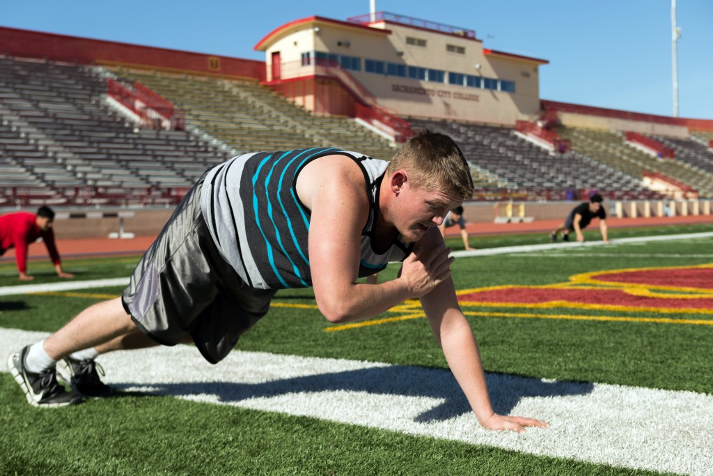 City College student Jacob Stout, biology major, exercises in Hughes Stadium for his boot camp fitness class on Monday. Hector Flores, Staff Photographer. | hectorfloresexpress@gmail.com